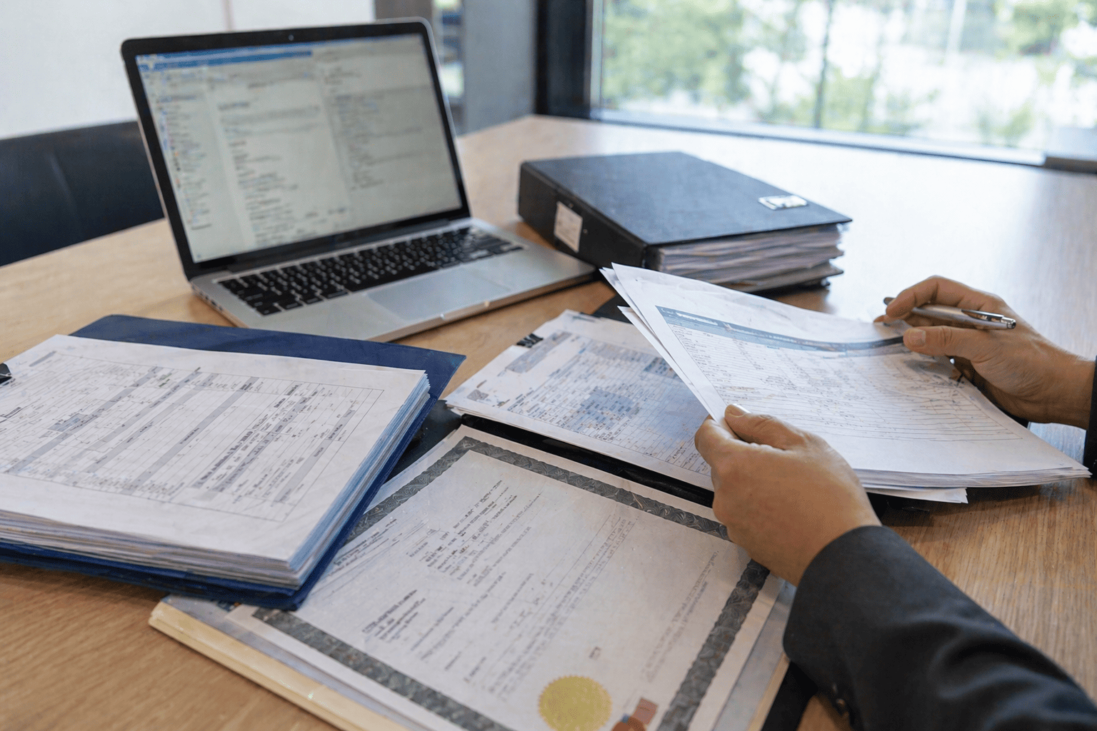 CARB P2 certification and compliance documents reviewed in professional workspace for cabinet material verification