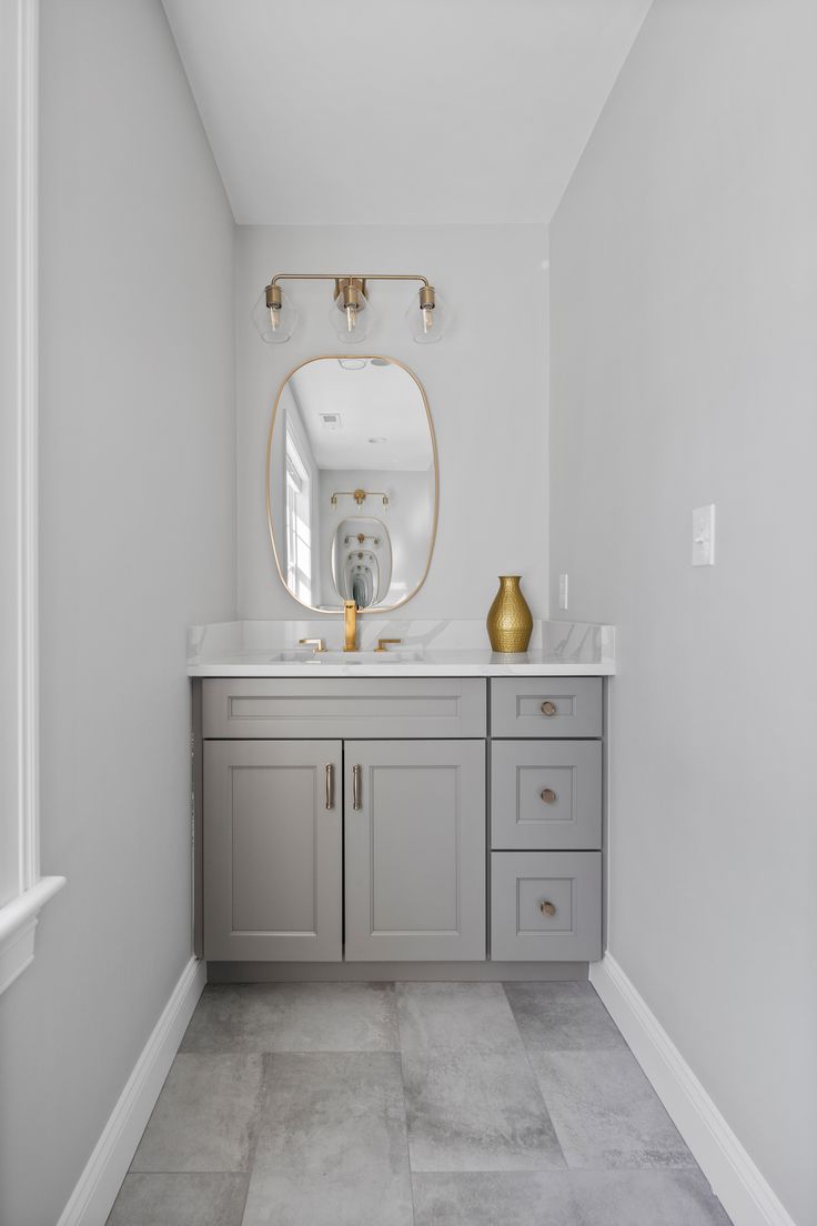 grey framed vanity cabinet used in residential bathroom design