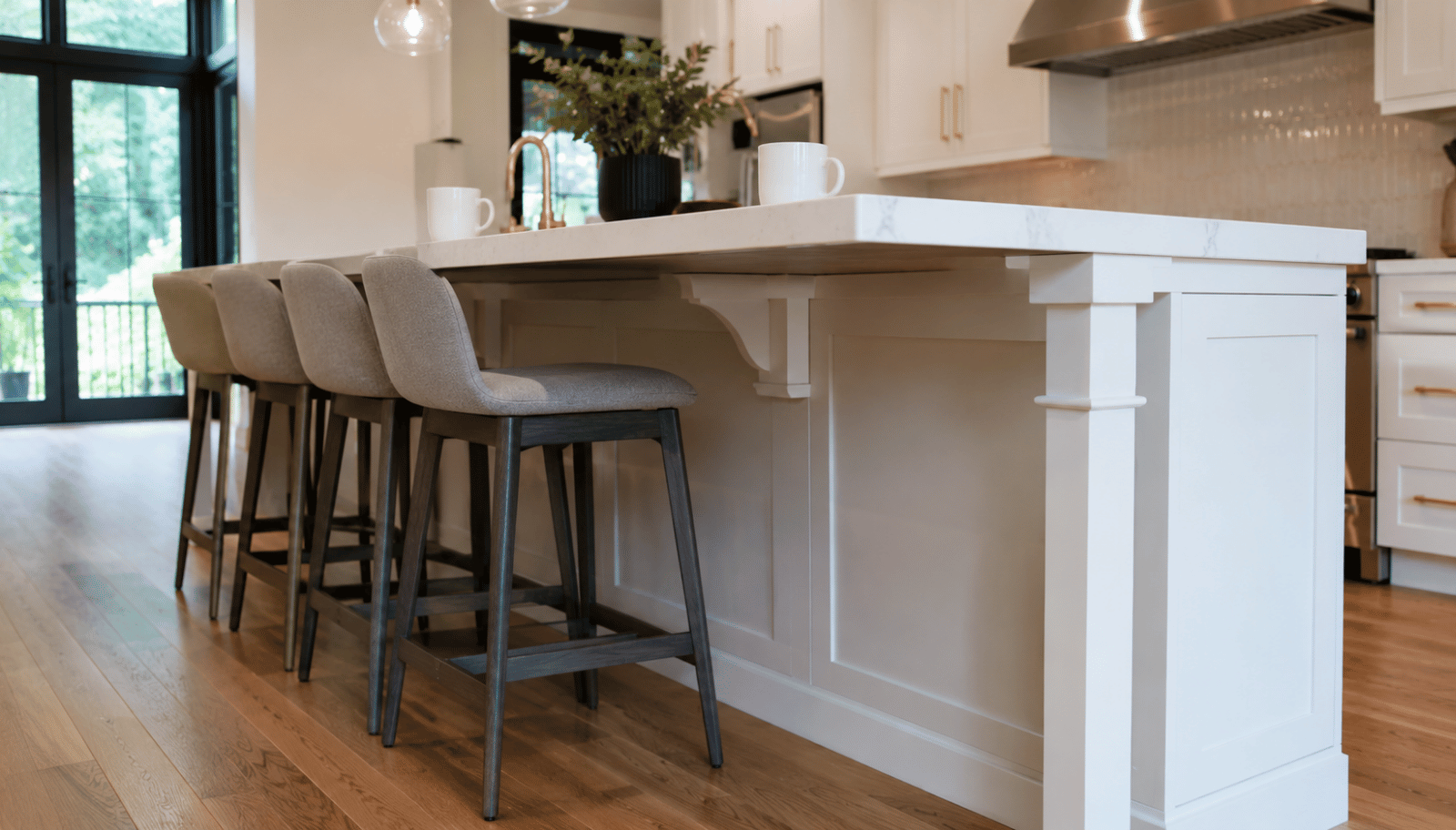 Kitchen island base cabinet with seating, countertop overhang, knee clearance, hidden support brackets, and modern bar stools