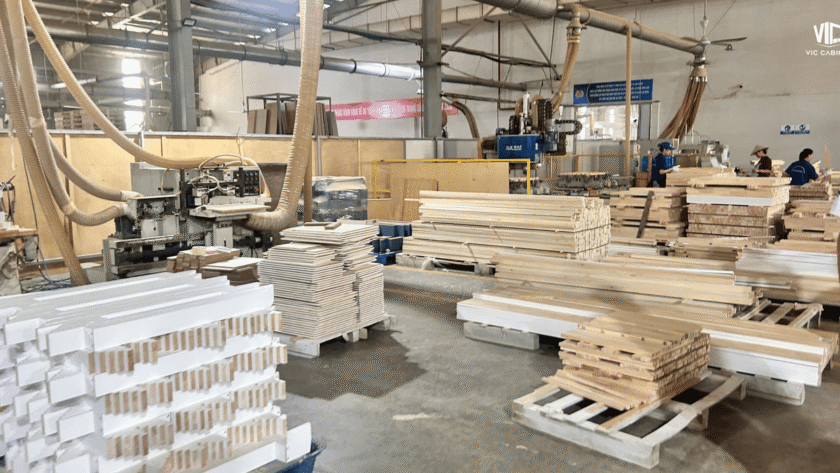 Wood cabinet components being processed on the production floor at the VIC Cabinet factory in Vietnam